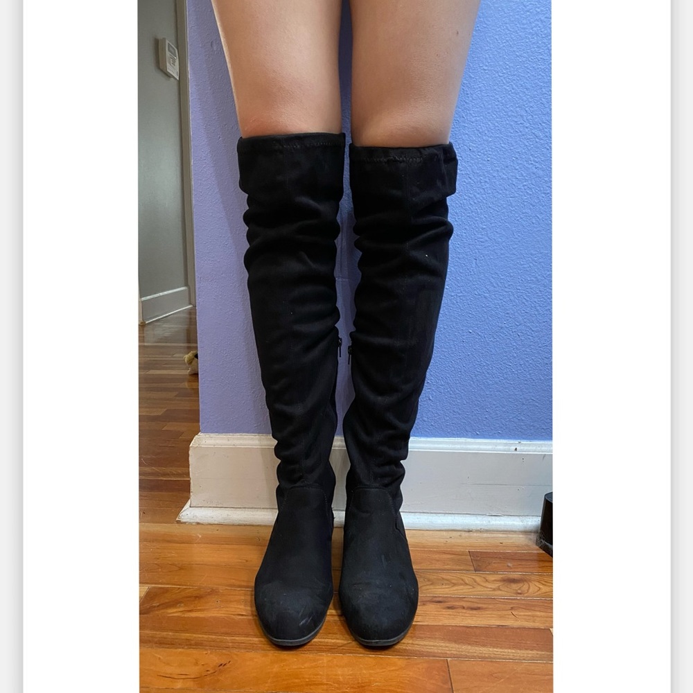 Black tall leg-lengthening over-the-knee boot